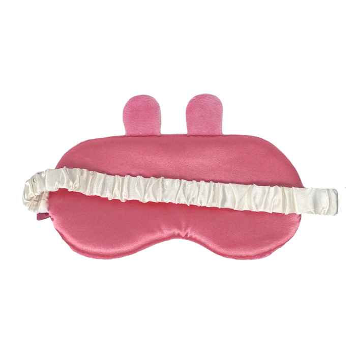A pink satin sleep mask with two small upright bunny ears on top and a white ruffled elastic strap, shown on a plain white background.