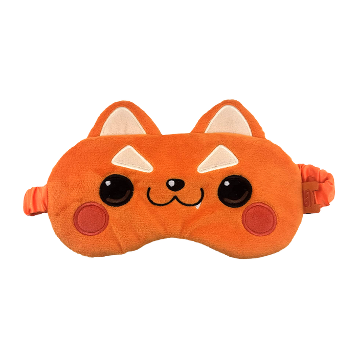 An orange plush sleep mask shaped like a cute cartoon fox face, with embroidered black eyes, a small black nose, white triangular ears, and red circular cheeks, shown on a plain white background.